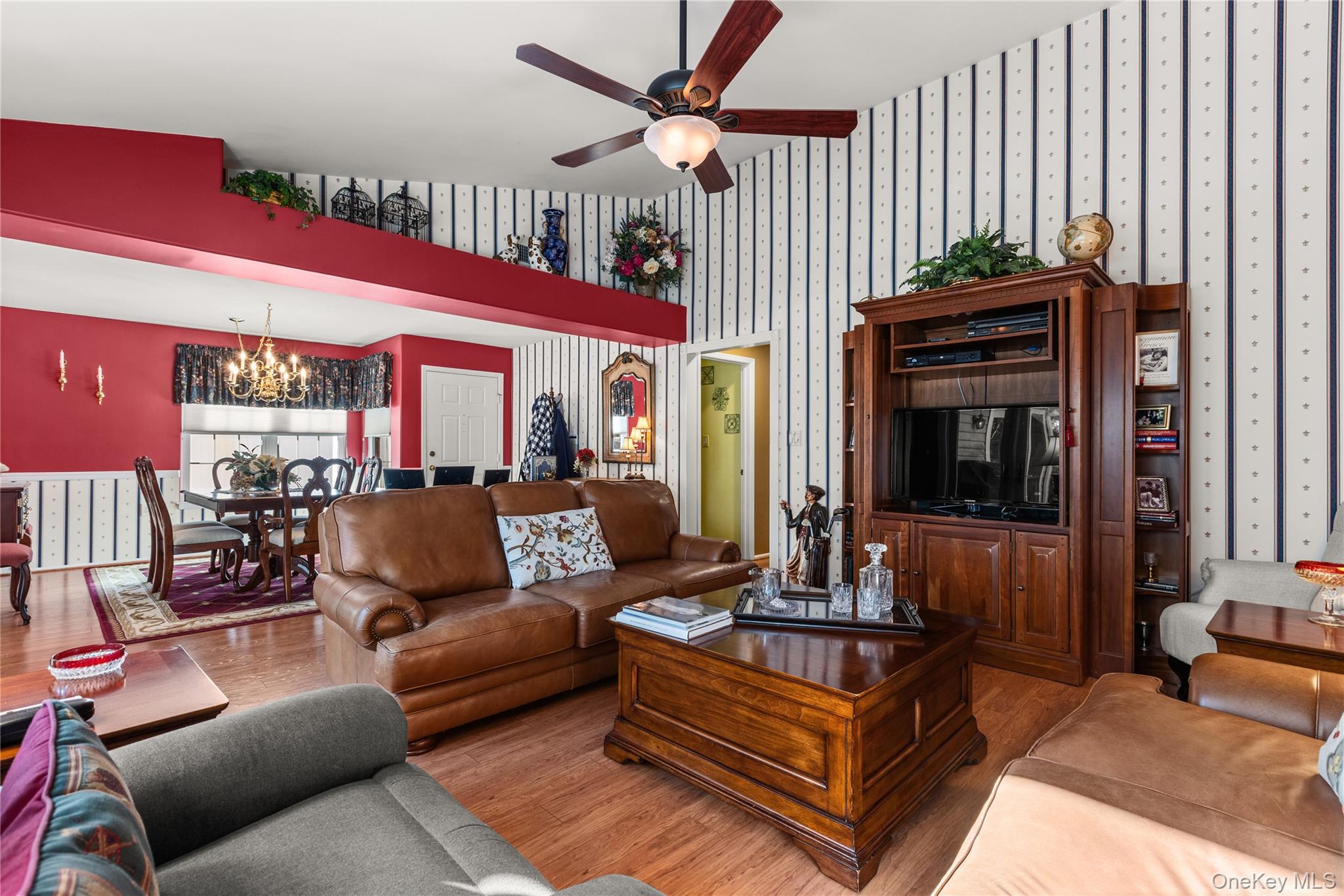 77 Glen Drive Ridge, NY 11961 - Photo 10 of 27 a living room with furniture a flat screen tv and a fireplace