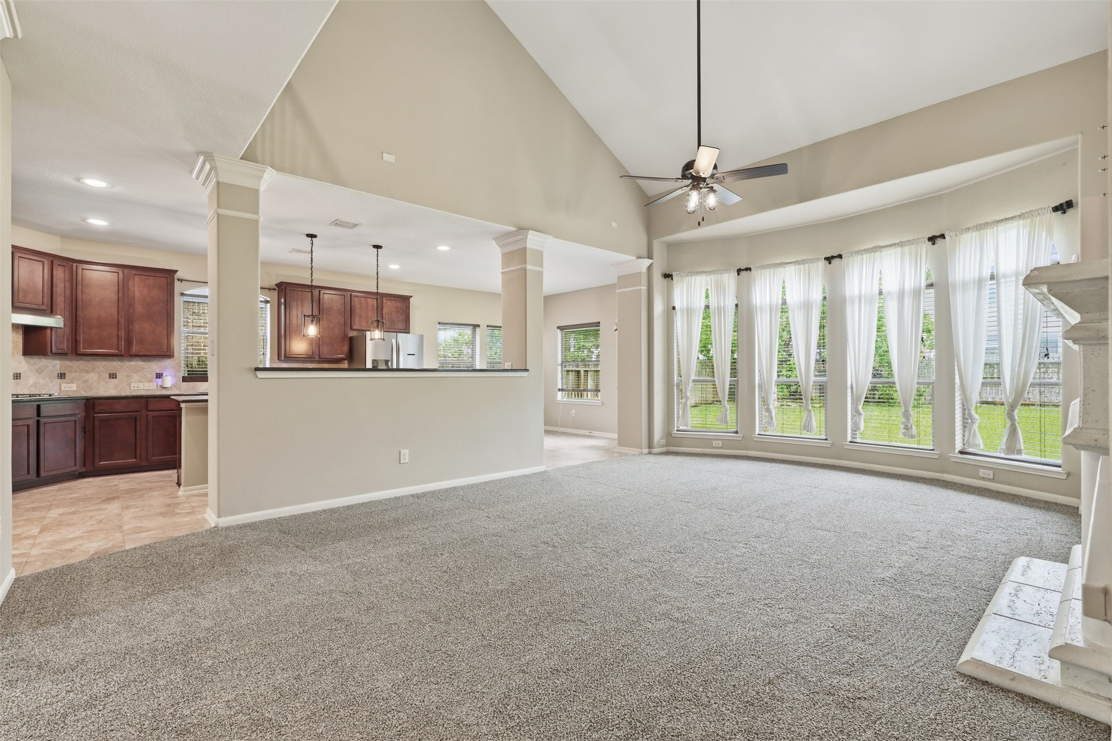 12410 Adams Ridge Lane Humble, TX 77346 - Photo 12 of 33 The living room is has open view to the kitchen yet separated by partial wall.