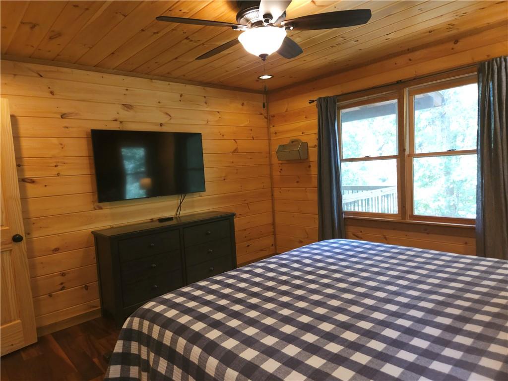 101 Hothouse Drive Mineral Bluff, GA 30559 - Photo 19 of 63 a bedroom with a bed and a flat screen tv