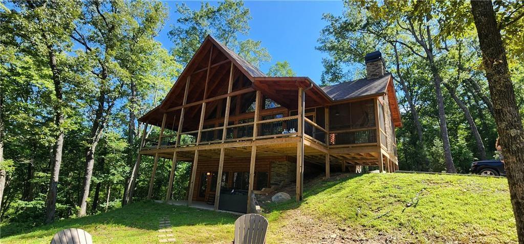 101 Hothouse Drive Mineral Bluff, GA 30559 - Photo 2 of 63 a view of a backyard with floor to ceiling window and tree