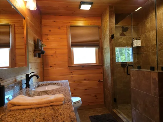 a bathroom with a shower and a mirror