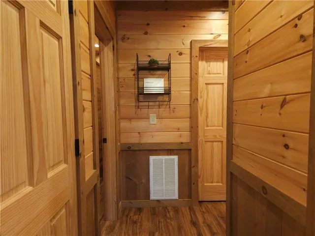 a view of a balcony with chairs and wooden floor