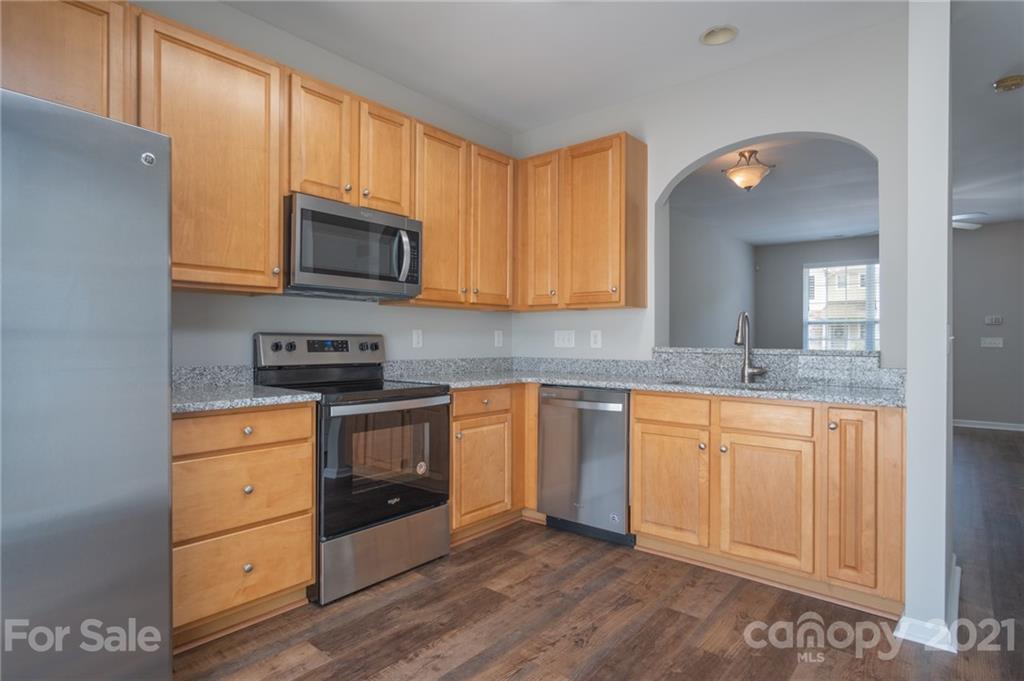 914 Copperstone Lane, Unit 177 Fort Mill, SC 29708 - Photo 11 of 27 a kitchen with stainless steel appliances granite countertop a stove a sink and a microwave
