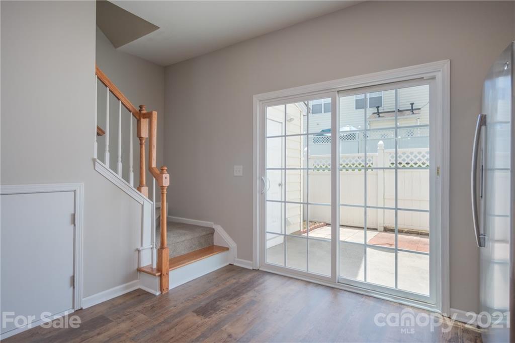 914 Copperstone Lane, Unit 177 Fort Mill, SC 29708 - Photo 13 of 27 a view of an empty room with wooden floor and a window
