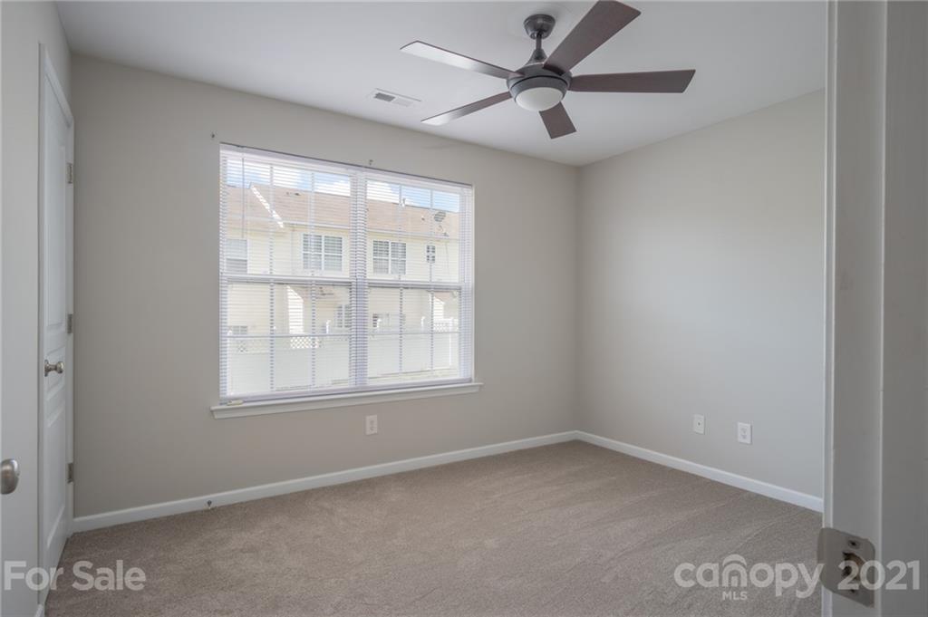 914 Copperstone Lane, Unit 177 Fort Mill, SC 29708 - Photo 15 of 27 an empty room with a window and a fan