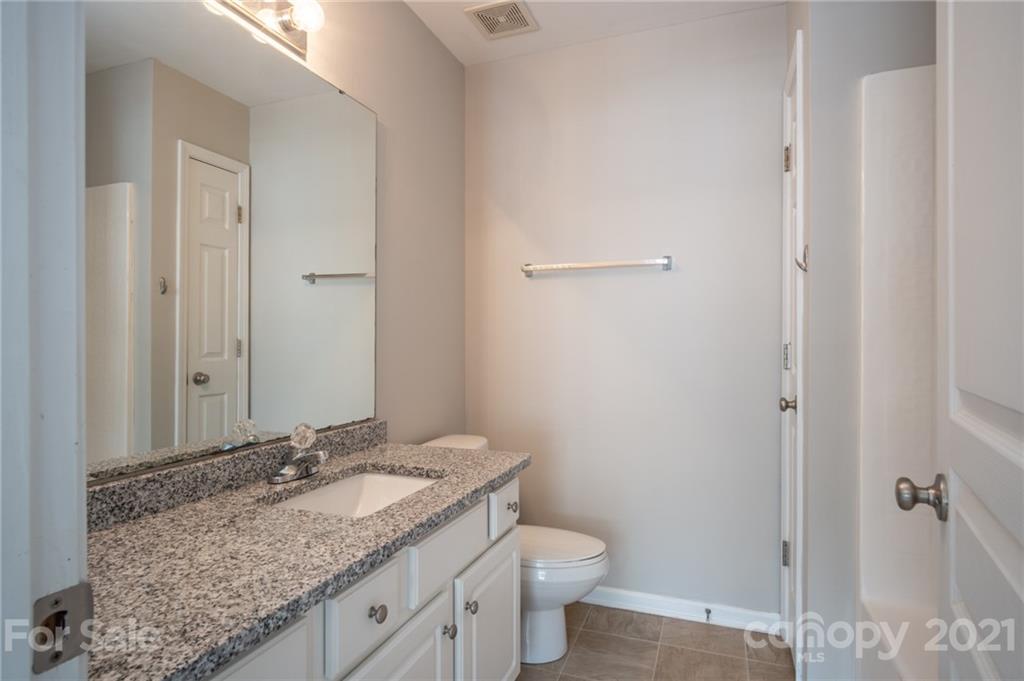 914 Copperstone Lane, Unit 177 Fort Mill, SC 29708 - Photo 20 of 27 a bathroom with a granite countertop sink and a mirror