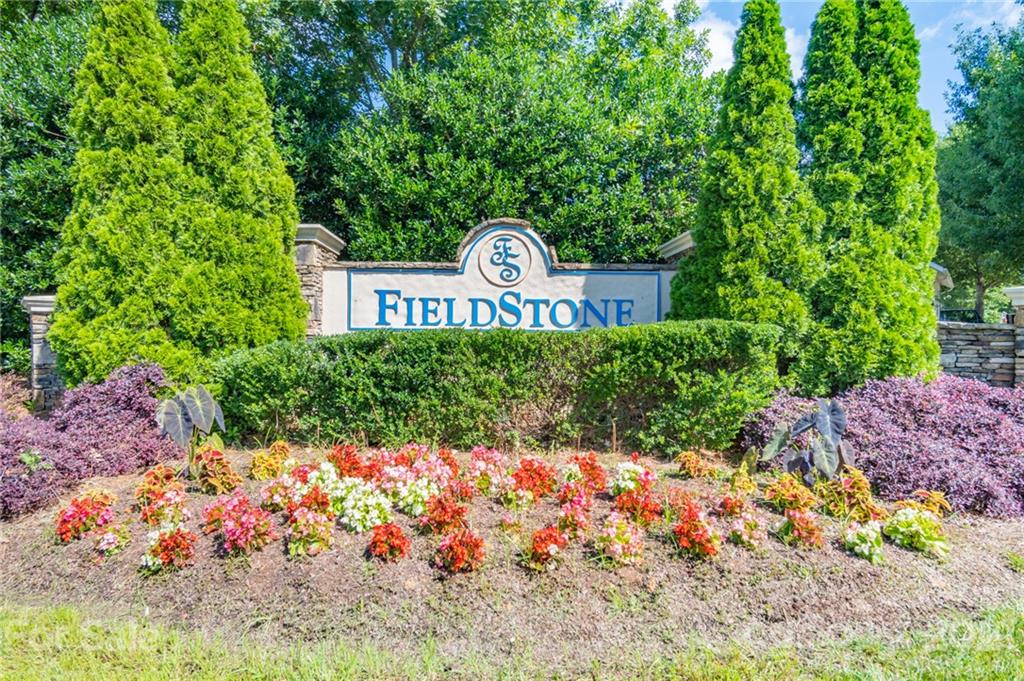 914 Copperstone Lane, Unit 177 Fort Mill, SC 29708 - Photo 25 of 27 a street sign in front of flowers