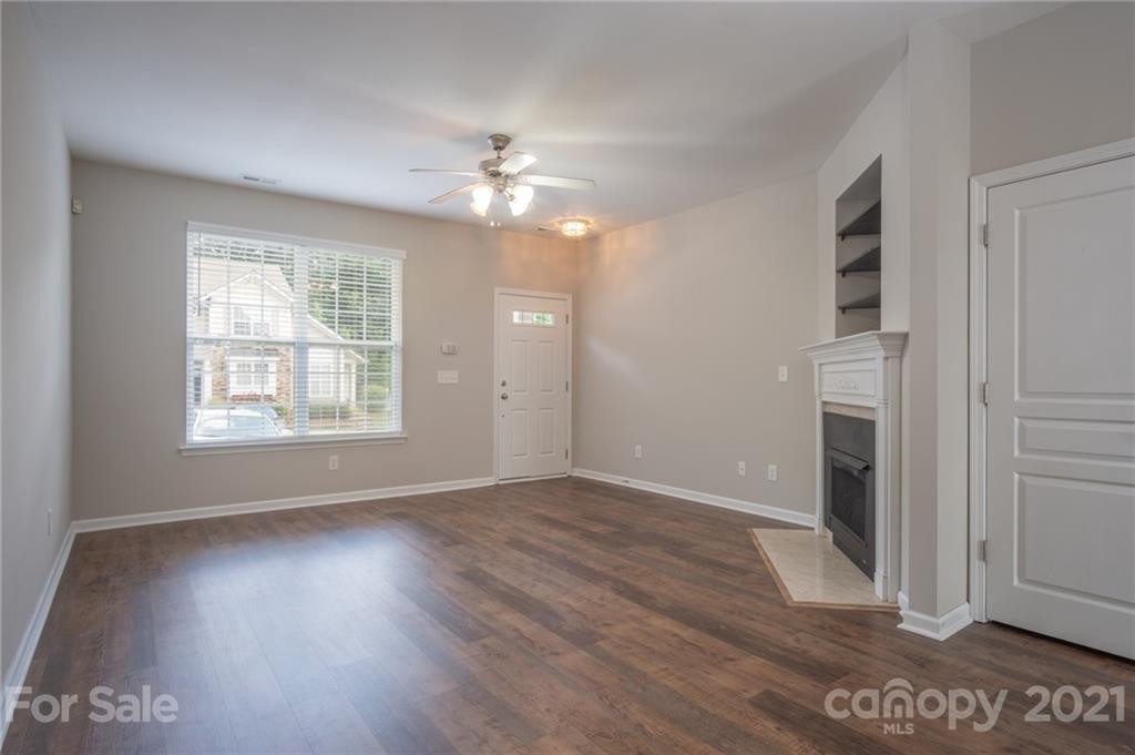 914 Copperstone Lane, Unit 177 Fort Mill, SC 29708 - Photo 6 of 27 an empty room with wooden floor chandelier and windows