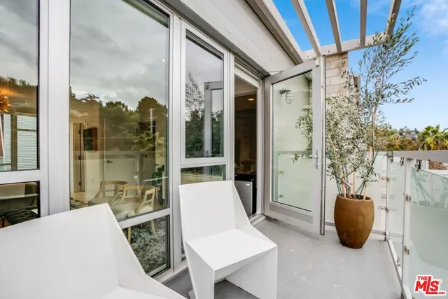 a view of balcony with couple of chairs