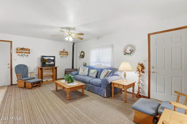 a living room with furniture and a lamp