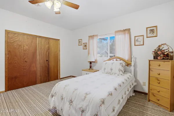 a bedroom with a bed and a dresser