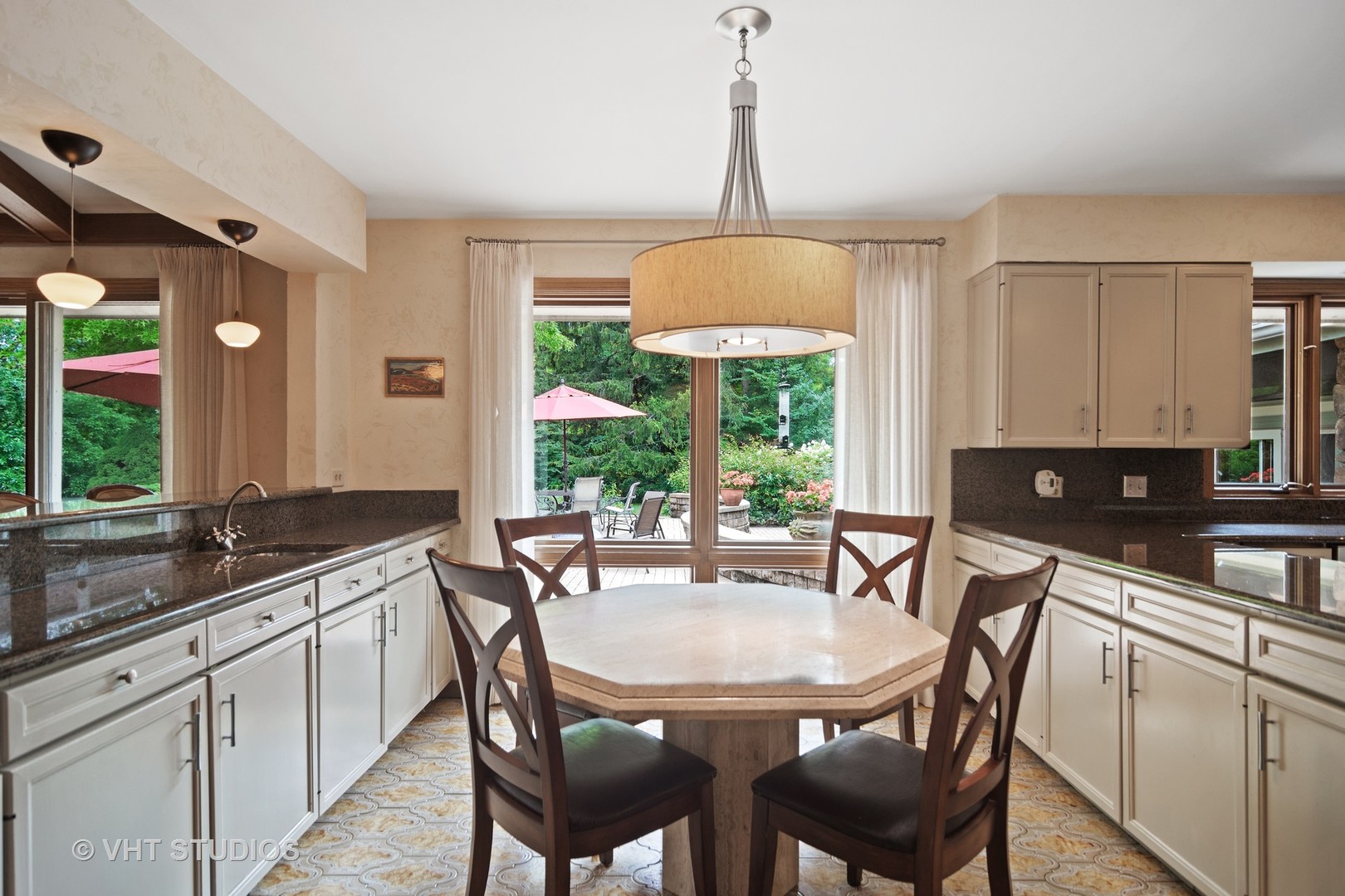 2327 Coach Road Long Grove, IL 60047 - Photo 14 of 58 a kitchen with a stove a sink a dining table and chairs