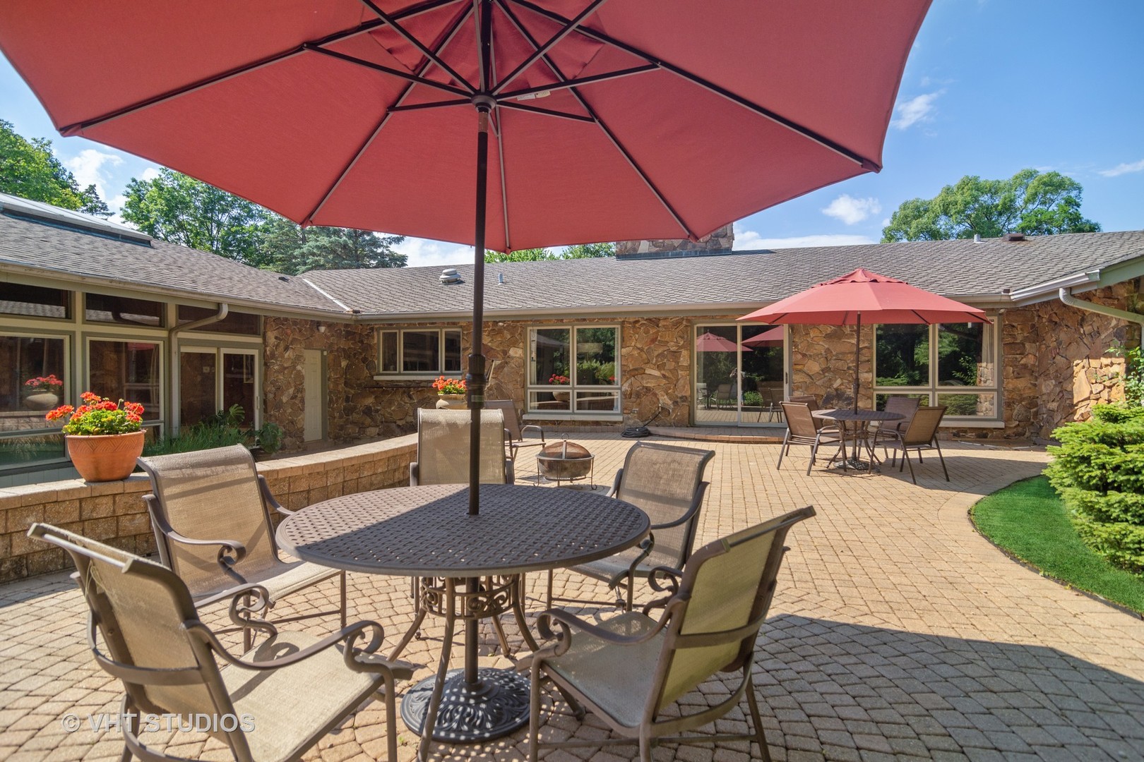 2327 Coach Road Long Grove, IL 60047 - Photo 34 of 58 a patio with a table and chairs under an umbrella