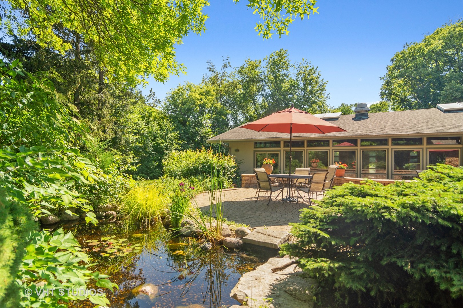 2327 Coach Road Long Grove, IL 60047 - Photo 47 of 58 a patio with a table and chairs under an umbrella