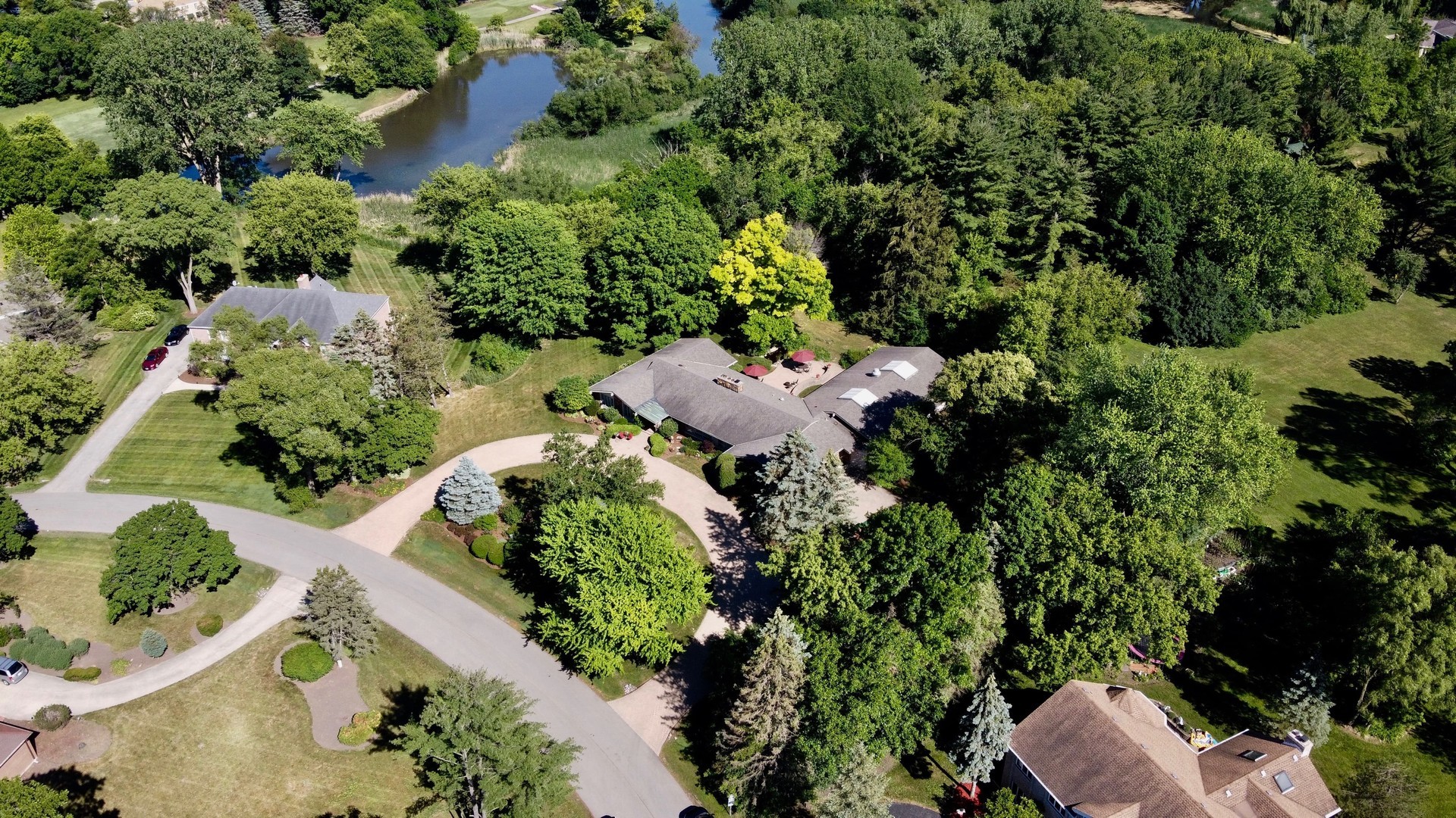 2327 Coach Road Long Grove, IL 60047 - Photo 50 of 58 an aerial view of a house with a yard and trees all around