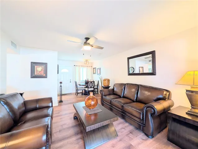 a living room with furniture and a lamp