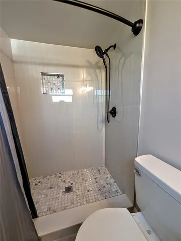 a bathroom with a toilet a sink and a mirror