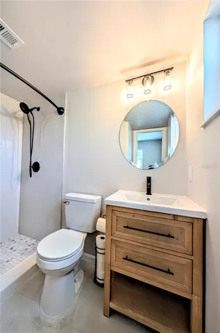 a bathroom with a shower and a toilet