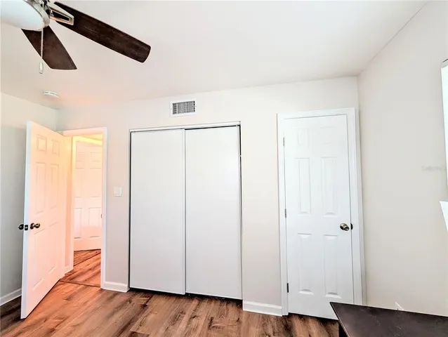 a bedroom with a bed and a desk