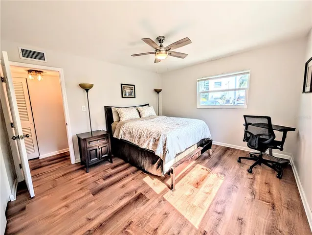 a bedroom with a large bed and a window