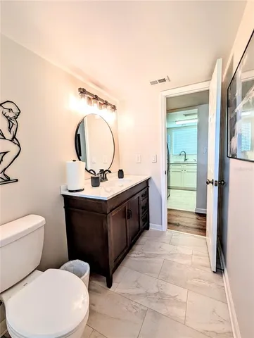 a bathroom with a toilet a sink and a mirror