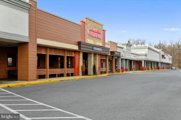 a view of swimming pool with outdoor seating and a garden