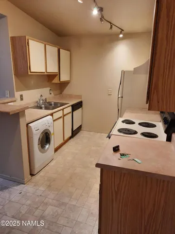 a kitchen with a stove and a sink