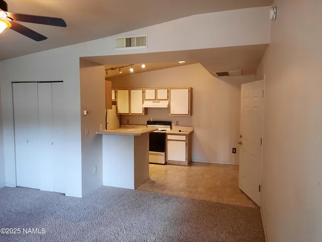 a kitchen with a refrigerator and a sink