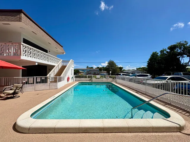 a swimming pool with outdoor seating and yard