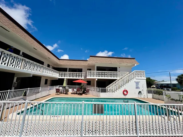 a view of a patio with a table and chairs