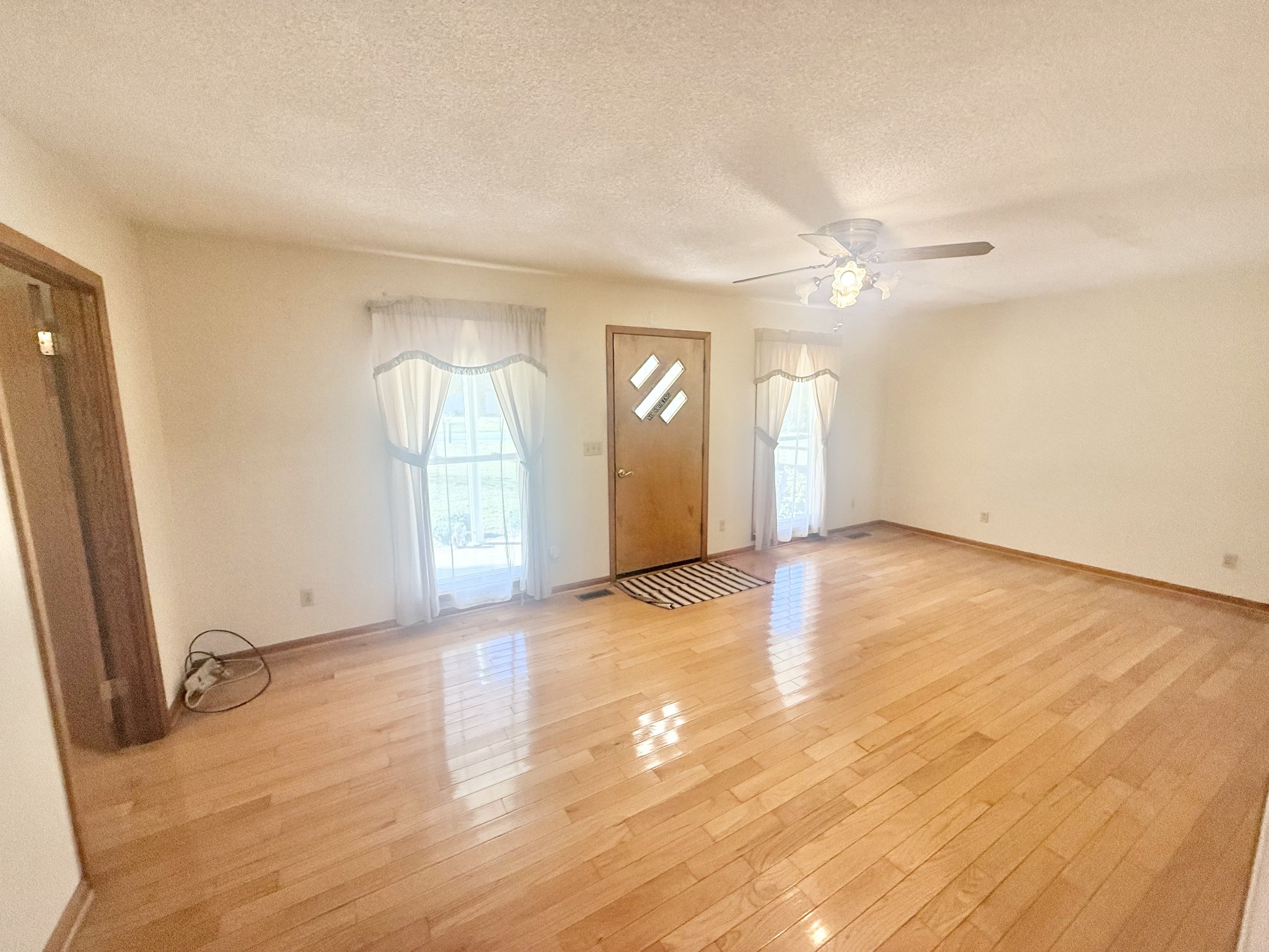 3065 Bucksnort Ridge Road Collinwood, TN 38450 - Photo 2 of 12 an empty room with wooden floor and windows
