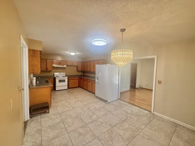 a view of kitchen with refrigerator and window