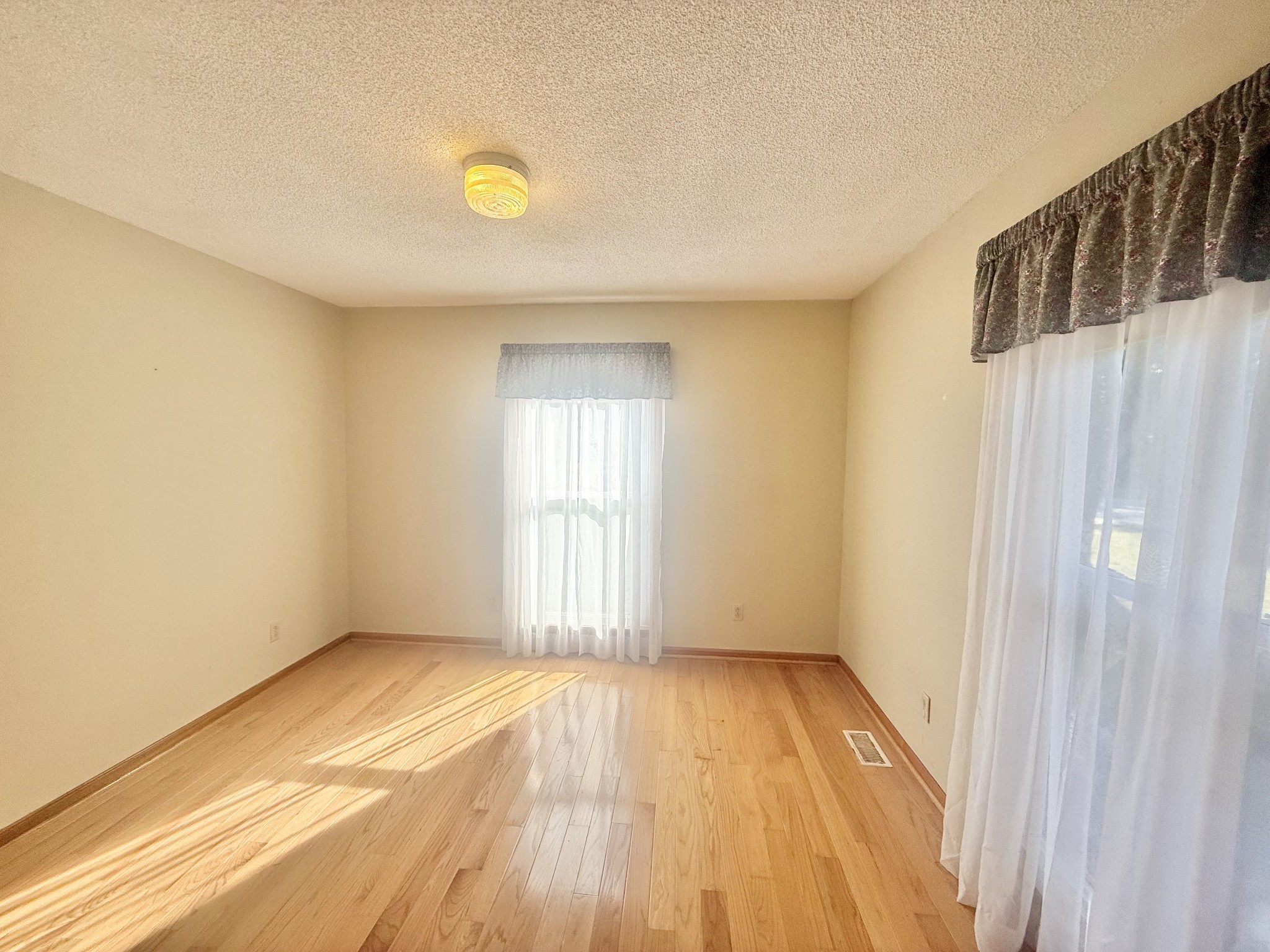 3065 Bucksnort Ridge Road Collinwood, TN 38450 - Photo 4 of 12 a view of an empty room with wooden floor and a window