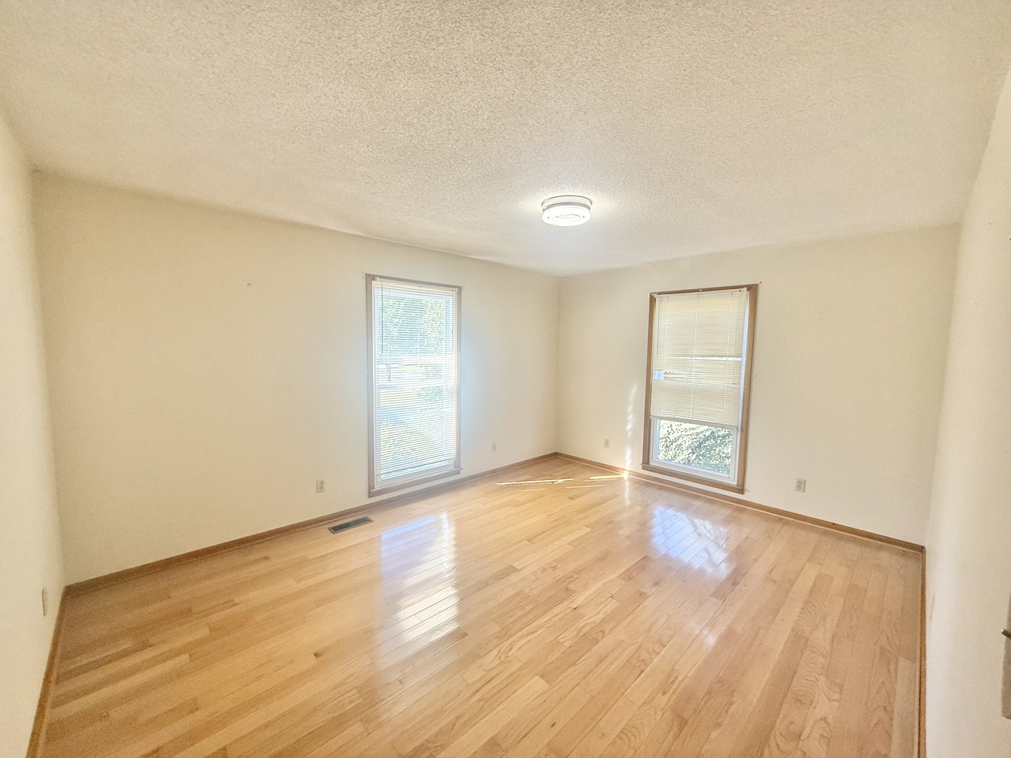 3065 Bucksnort Ridge Road Collinwood, TN 38450 - Photo 7 of 12 an empty room with wooden floor and windows
