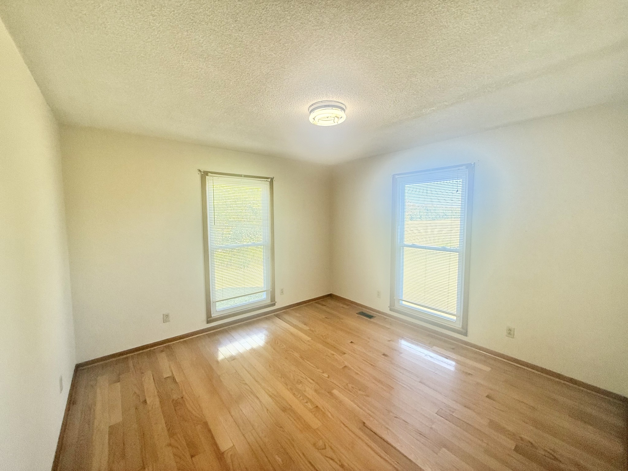 3065 Bucksnort Ridge Road Collinwood, TN 38450 - Photo 9 of 12 an empty room with wooden floor and windows