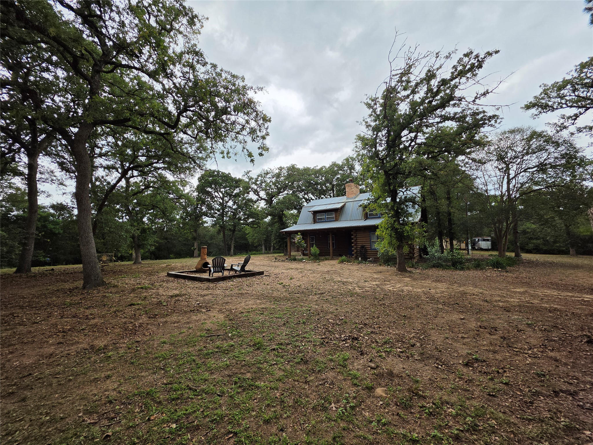 1053 East County Rd F Lexington, TX 78947 - Photo 1 of 38 a view of a backyard with large trees