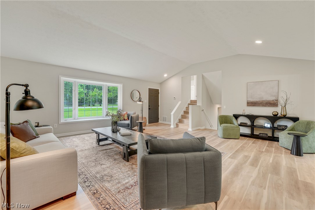 646 Ledge Road Macedonia, OH 44056 - Photo 2 of 28 Spacious living area featuring light wood-finish flooring, vaulted ceilings, recessed lighting, and a prominent bay window