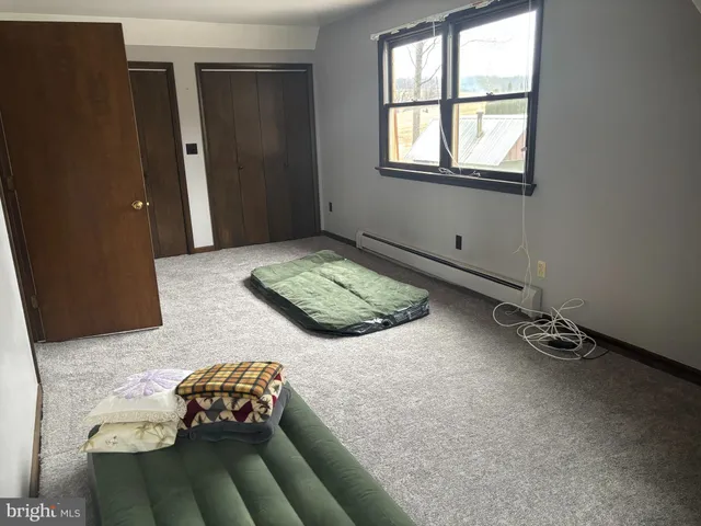 a bedroom with bed and window