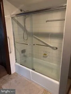 a bathroom with a glass shower door