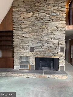 a front view of a stone house with a garage