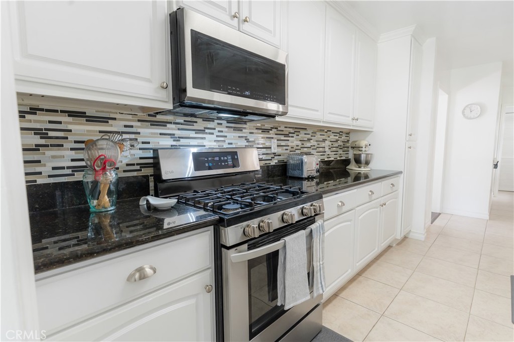 4743 Coldbrook Avenue Lakewood, CA 90713 - Photo 14 of 39 a kitchen with stainless steel appliances granite countertop a stove microwave and sink