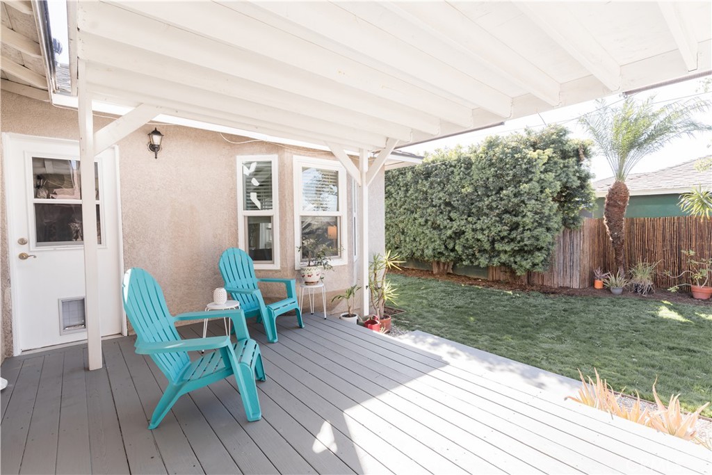 4743 Coldbrook Avenue Lakewood, CA 90713 - Photo 38 of 39 a view of a deck with table and chairs with wooden floor and fence