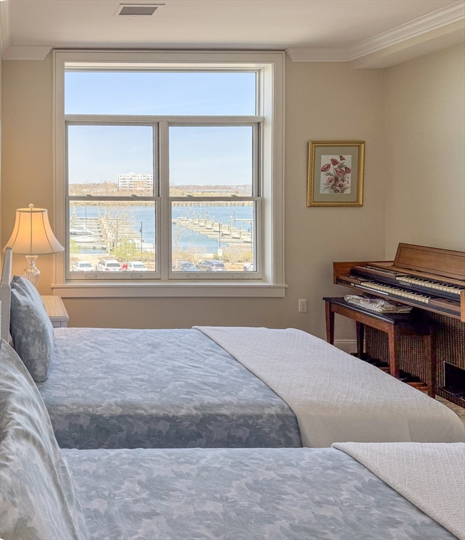 23 Shipyard Drive, Unit 303 Hingham, MA 02043 - Photo 11 of 13 a bedroom with a bed and a window