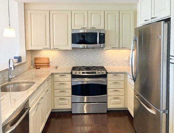 23 Shipyard Drive, Unit 303 Hingham, MA 02043 - Photo 5 of 13 a kitchen with stainless steel appliances a stove a microwave and a refrigerator