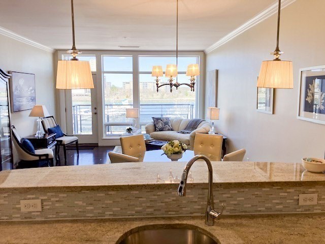 23 Shipyard Drive, Unit 303 Hingham, MA 02043 - Photo 6 of 13 a living room with fireplace furniture and a large window
