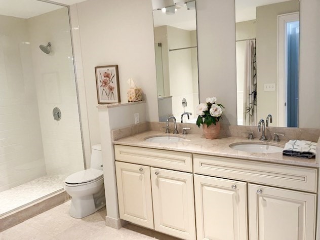 23 Shipyard Drive, Unit 303 Hingham, MA 02043 - Photo 8 of 13 a bathroom with a granite countertop sink a toilet and a large mirror