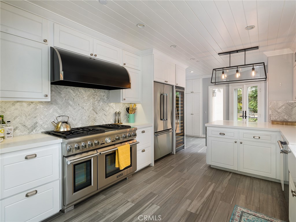 a kitchen with stainless steel appliances a sink a stove a microwave and cabinets