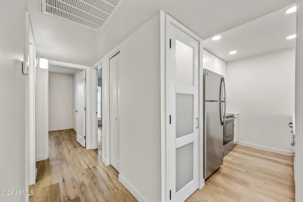 a view of a hallway with wooden floor and staircase