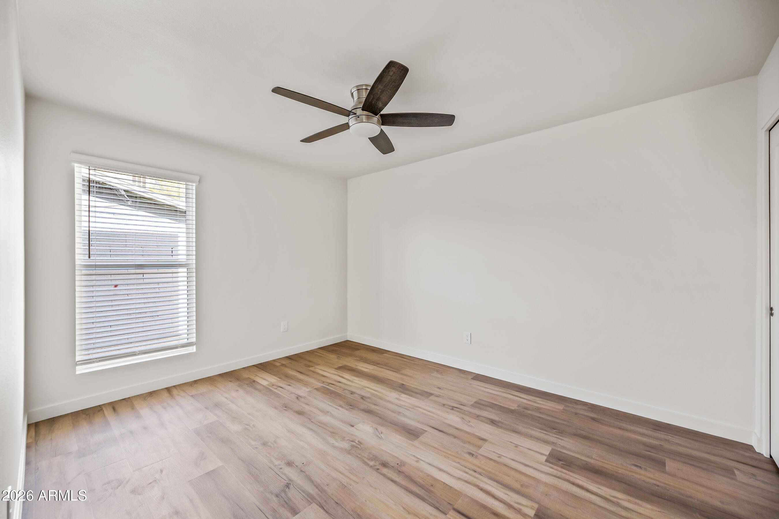 4139 North 27th Street, Unit 3 Phoenix, AZ 85016 - Photo 19 of 30 wooden floor in an empty room with a window