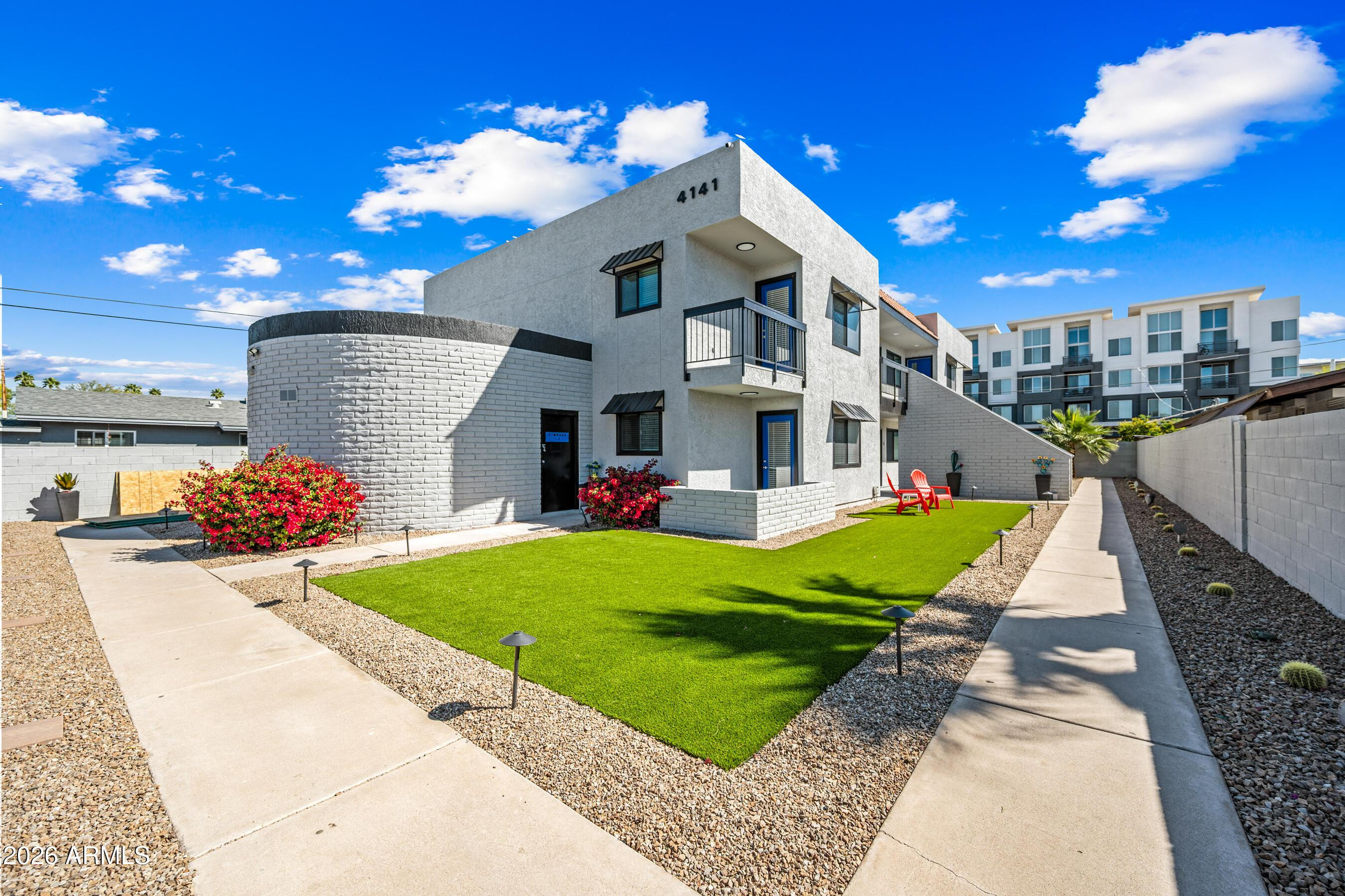 4139 North 27th Street, Unit 3 Phoenix, AZ 85016 - Photo 2 of 30 a front view of a house with a yard and potted plants